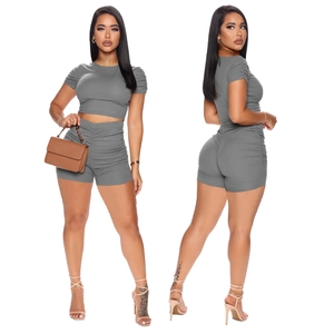 Detail of grey ribbed knit crop top and high-waisted shorts with side ruching details