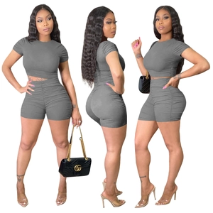 Detail view of grey ribbed two-piece set with shirred sleeve and side drawstring shorts
