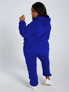 Detail of dark blue plush hoodie and matching joggers on model, back and side view