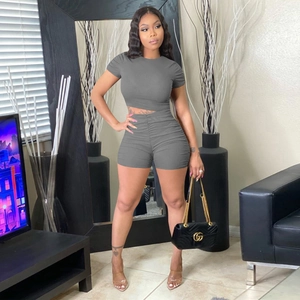 Detail of grey ribbed knit crop top and high-waisted ruched shorts for women