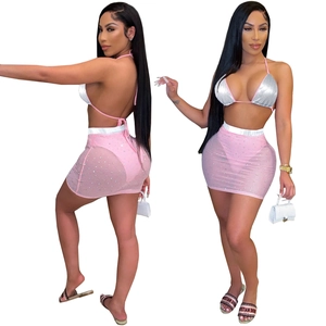 Women's two-piece set with silver sequin halter top and pink mesh rhinestone mini skirt