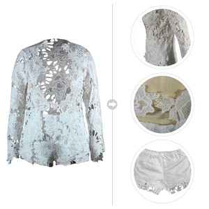 Close-up of white lace two-piece set with detailed rose patterns and scalloped edges