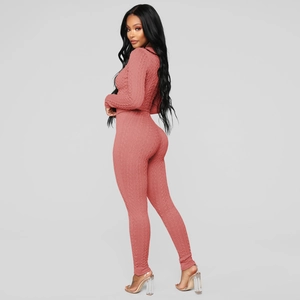 Détail de la maille torsadée rose sur l'ensemble deux pièces ajusté pull et legging