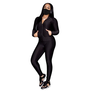 Détail de l'ensemble de yoga noir à texture gaufrée avec veste zippée et legging taille haute