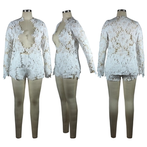 Detail of white floral lace long sleeve top and matching high waist shorts two-piece set