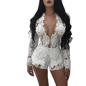 Close-up of intricate floral lace texture on white long-sleeve V-neck bodysuit