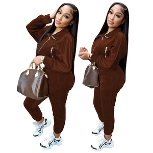 Deep brown velvet two-piece track suit with zipper pockets and matching jogger pants