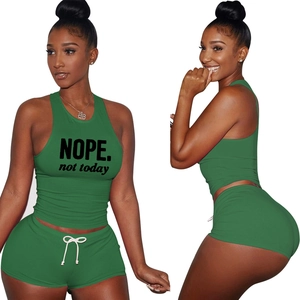 Close-up of green two-piece set featuring NOPE print and white drawstring details