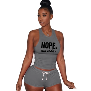 Detail of grey sports set featuring NOPE print ribbed tank top and drawstring shorts