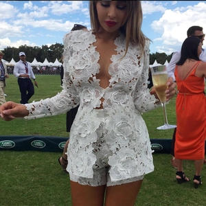 Detailed view of white floral lace texture and deep V-neck design on the two-piece set