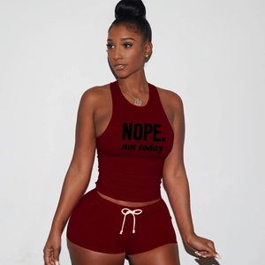 Detail of burgundy racerback tank top with NOPE print and drawstring shorts set