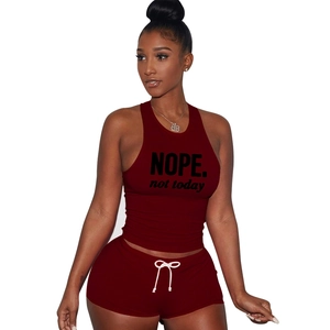 Close-up of burgundy cotton sports set featuring NOPE print crop top and drawstring shorts