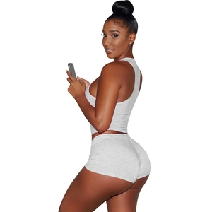 Detail view of the gray sleeveless crop top and matching shorts on a model profile