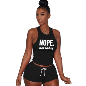 Detail of black sports set featuring white NOPE. not today print and drawstring shorts