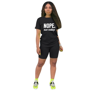 Dettaglio del set sportivo due pezzi con t-shirt stampata NOPE e pantaloncini ciclisti