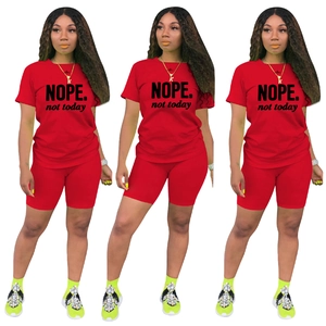 Completo sportivo da donna due pezzi con t-shirt rossa a maniche corte e pantaloncini da ciclista