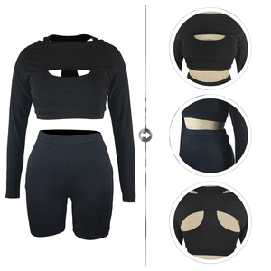 Detail of black sports set featuring cutout long sleeve top and high waist cycling shorts