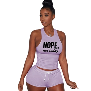 Detailed view of NOPE printed sports tank top and shorts set in purple cotton fabric