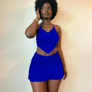 Detailed view of royal blue two-piece set featuring ruched mini skirt and halter top