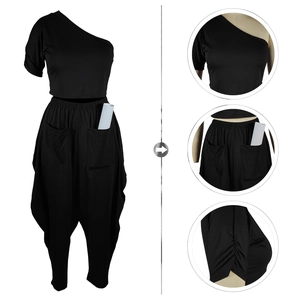 Detail view of black one-shoulder top and harem pants set with deep cargo utility pockets