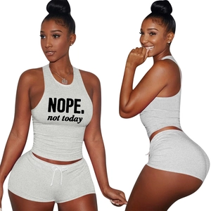 Women's two-piece grey sports set with NOPE print crop top and drawstring shorts