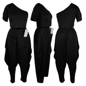 Detail of black one shoulder crop top and high waist harem pants set with side pockets