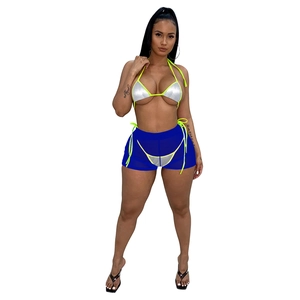 Dettaglio bikini metallizzato argento con bordo neon e pantaloncini in rete blu