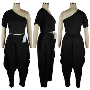 Detailed views of women's black one-shoulder cropped top and harem pants with side pockets