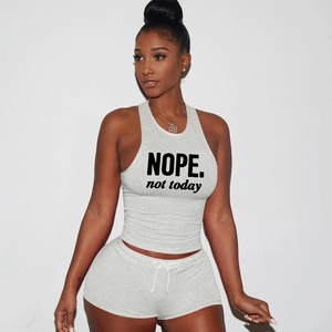 Detail of grey cotton two-piece set featuring NOPE print crop top and drawstring shorts