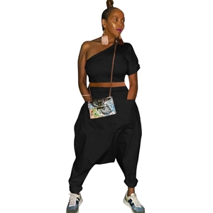 Detail view of black off-shoulder crop top and oversized harem pants with deep pockets