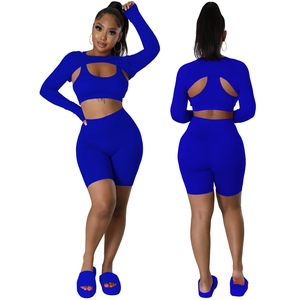 Three-piece royal blue athletic set featuring a hollow long-sleeve shrug and high-waist shorts