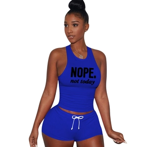 Close-up of royal blue cotton sports set featuring NOPE print halter top and drawstring shorts