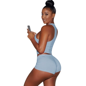 Side view of light blue sports crop top and tight shorts set on white background