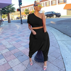 Detail view of cotton two-piece set featuring harem pants with large side pockets