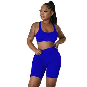 Front view of royal blue athletic set featuring a racerback sports bra and biker shorts