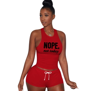 Detail of red sports set showing NOPE. not today print and white drawstring on shorts