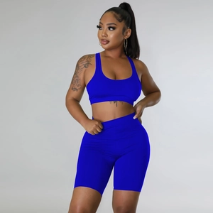 Detail of electric blue sports bra and high-waisted shorts set on professional studio model