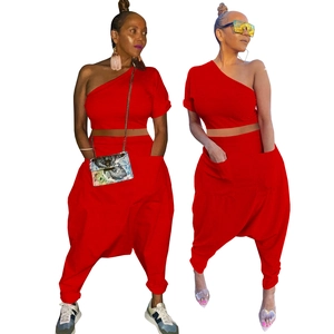 Detail of red one-shoulder crop top and harem pants set with large utility side pockets