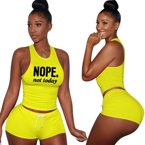 Close-up of yellow sporty two-piece set with NOPE print and elastic drawstring waist
