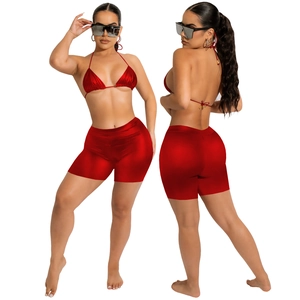 Detail of red metallic PU bikini set with halter top and high-waisted slim shorts
