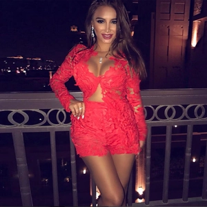 Detailed view of red floral lace fabric with intricate cut-outs on a long-sleeve outfit
