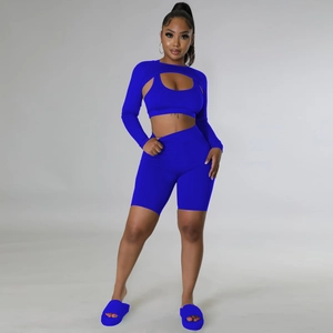 Three-piece royal blue athletic set featuring a hollow shrug, sports bra, and cycling shorts
