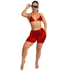 Close-up of red metallic PU bikini set with halter top and high-waisted shorts