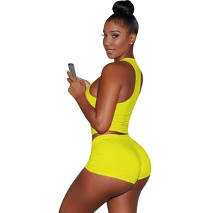 Detail view of yellow two-piece cotton workout set featuring crop top and high waist shorts