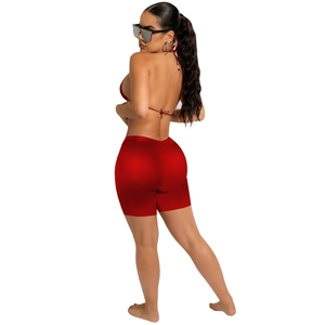 Detail of red stretch PU two-piece bikini set with halter top and high-waisted shorts