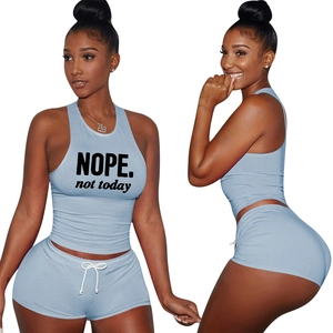 Detail showing the light blue two-piece crop top and shorts set with NOPE. print