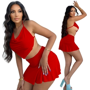 Detailed view of red halter cowl neck crop top and high waist ruched mini skirt set