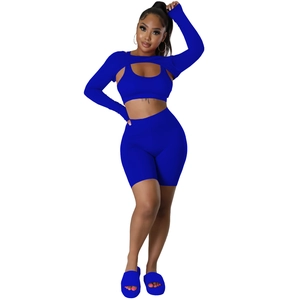 Three-piece royal blue athletic set featuring a long sleeve crop top, vest and shorts