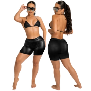 Women's black two-piece PU bikini set with halter top and shiny stretch shorts