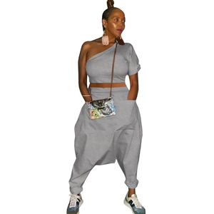 Detail of grey one-shoulder top and harem pants set with large functional side pockets